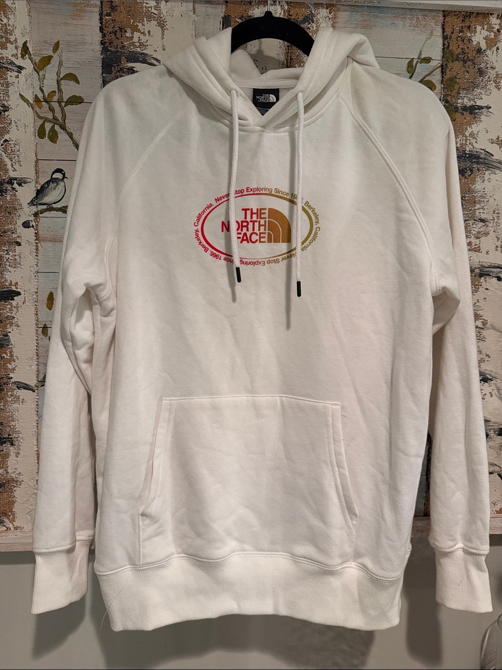 The North Face Cream Pullover Hoodie with Red and Gold Logo